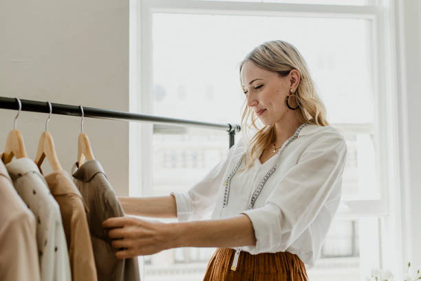 istock Fashion stylist sorting the clothing rack 2157201133