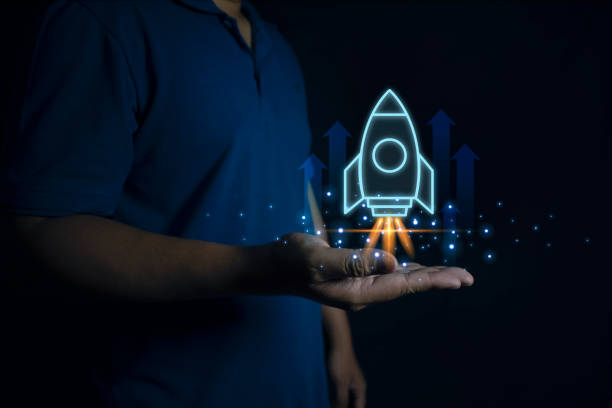 istock Businessman holding holographic rocket symbolizing startup success and growth acceleration with virtual rocket icon and up arrow for fast start up business. Startup business concept. 2157202537