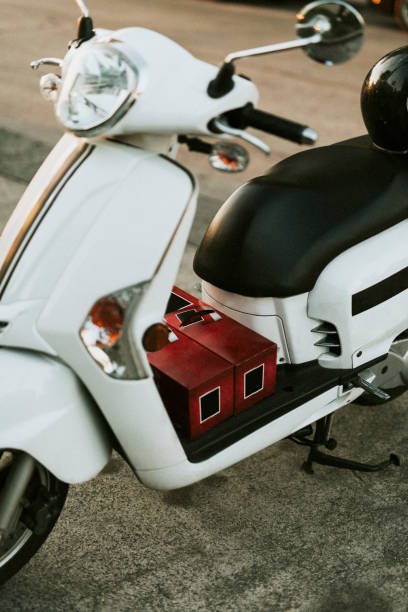 istock White scooter parked on the sidewalk 2157202719