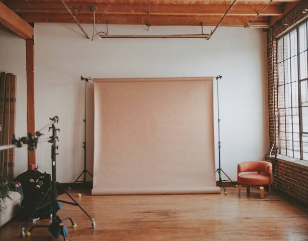 istock Beige backdrop at a cool industrial photography studio 2157202760