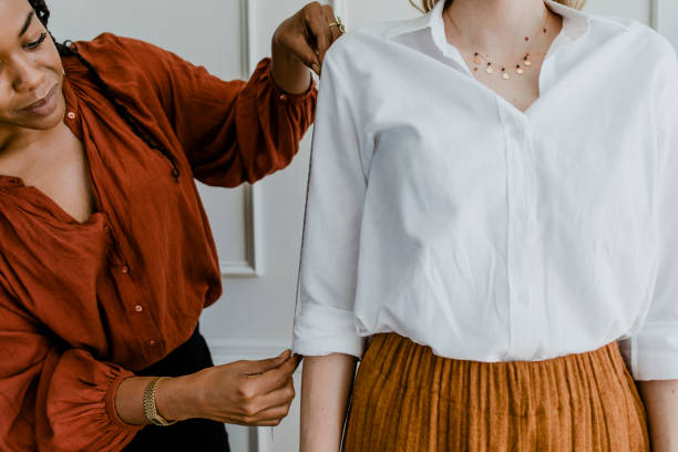 istock Fashion stylist measuring a customer's arm 2157206254