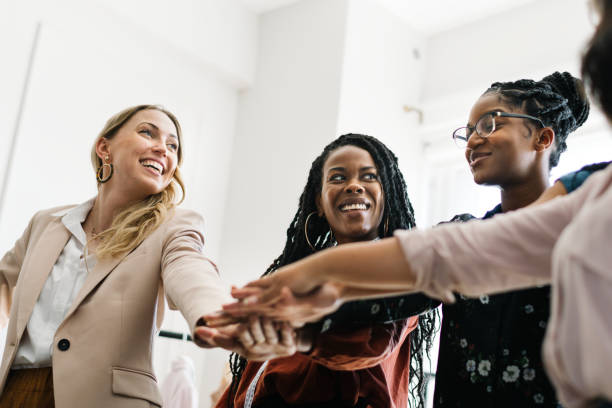 istock Empowering businesswomen stacking their hands 2157206338