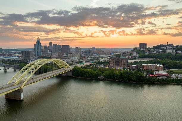 istock Highway traffic in Cincinnati, Ohio on Daniel Carter Beard Bridge with brightly illuminated high skyscraper buildings in downtown district. American city with business financial district at sunset 2157207401
