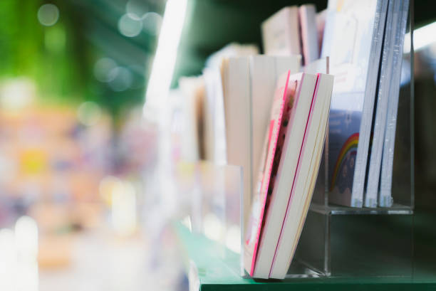 istock Book stack in the library room and blurred bookshelf background for business, education and back to school concept 2157207548