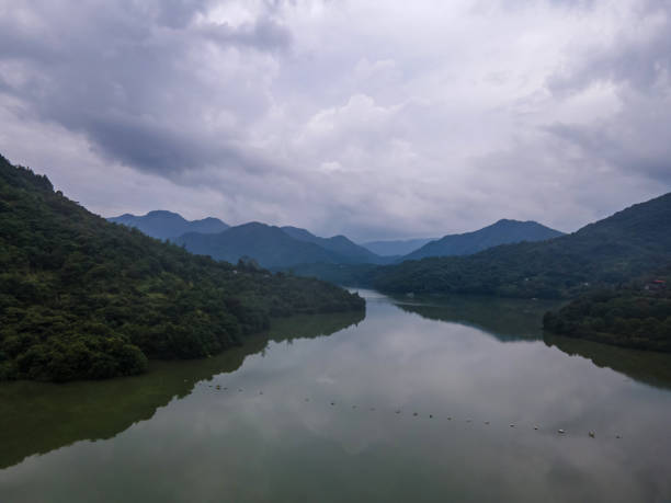 istock Cloudy weather, lake between mountains and forests 2157207638