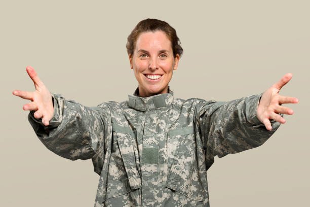 istock Friendly female soldier reaching out her arms 2157211651