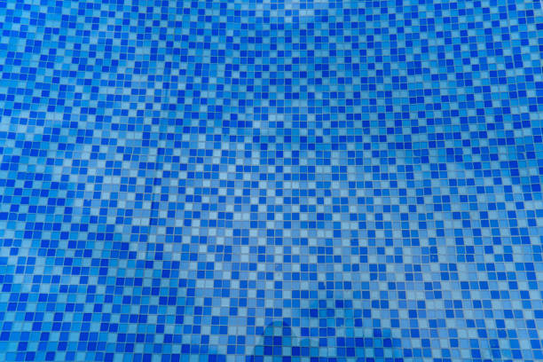 Shades of blue tile on the bottom of a pool