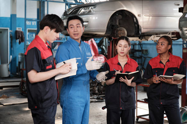 istock A supervisor engineer is training mechanic workers about car repair at a garage. 2157213797
