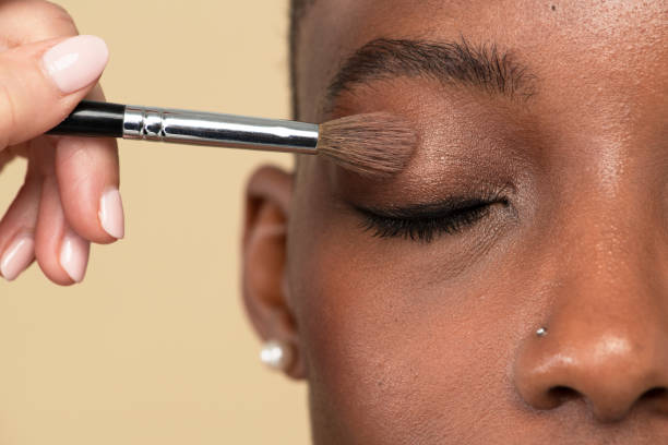 istock Makeup artist applying eye shadow on a black woman 2157214426