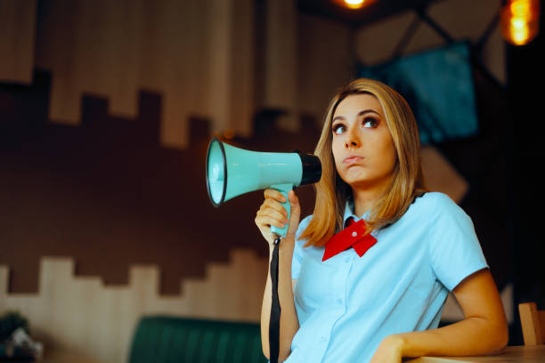istock Tired Fast-Food Worker Holding a Loudspeaker for Advertisement 2157215716