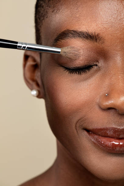 istock Makeup artist applying eye shadow on a black woman 2157216393