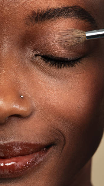 istock Makeup artist applying eye shadow on a black woman 2157216436