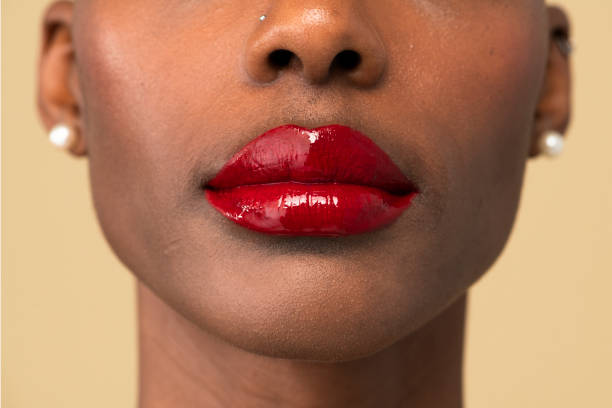 istock Black woman wearing a glossy red gloss 2157216610
