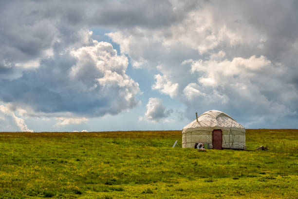 Lonely yurt (traditional nomadic dwelling) on a high mountain plateau in the first summer days