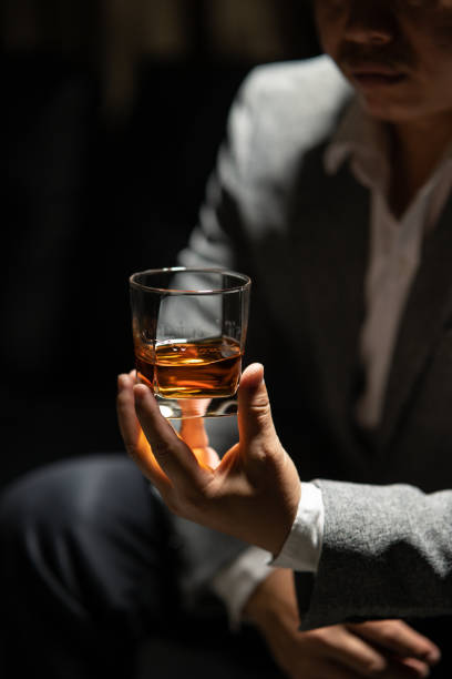 istock Barman pouring whiskey whiskey glass beautiful night 2157217704