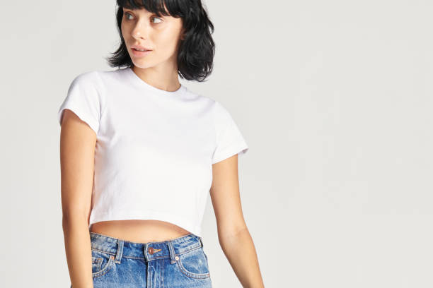 istock Woman in a white crop top and blue jeans 2157217813