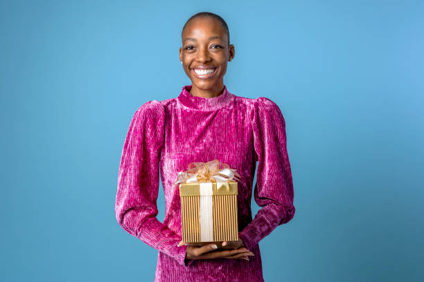 istock Happy black woman holding a gift box 2157218063