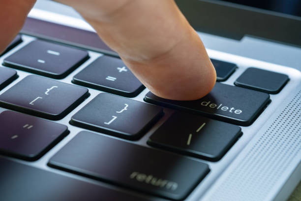 istock Finger of the computer user, he presses the delete button on the computer keyboard. 2157221121