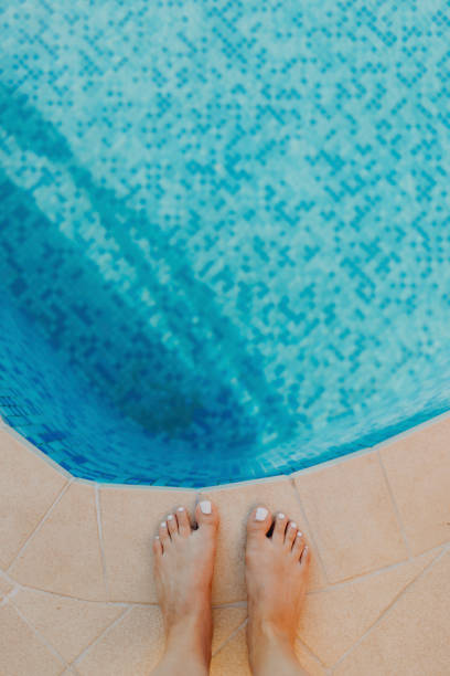 istock Woman standing by the blue pool 2157223223