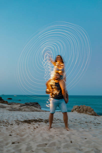 istock Woman riding on man's shoulder at the beach 2157223300