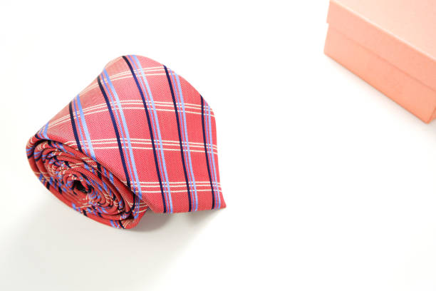 A checked pattern color polyester fabric necktie rolled on white background close-up view, Father's day concept, no people
