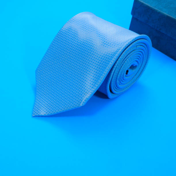 istock A blue color polyester fabric necktie rolled on blue background close-up view single object, Father's day concept, no people 2157227529