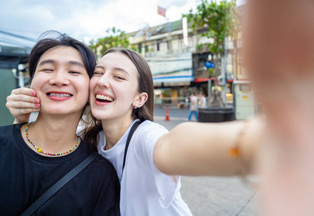 istock playful young couple selfie and making face 2157229810