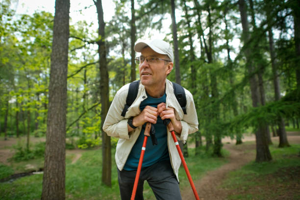 istock Senior man hiking in a forest in springtime or summer 2157230073