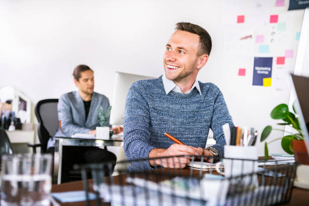 Happy businessman taking notes in the  office