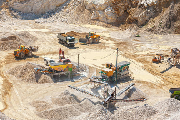 istock Industrial Activity in an Open-Pit Quarry - Heavy Machinery at Work in a Surface Mine 2157231240