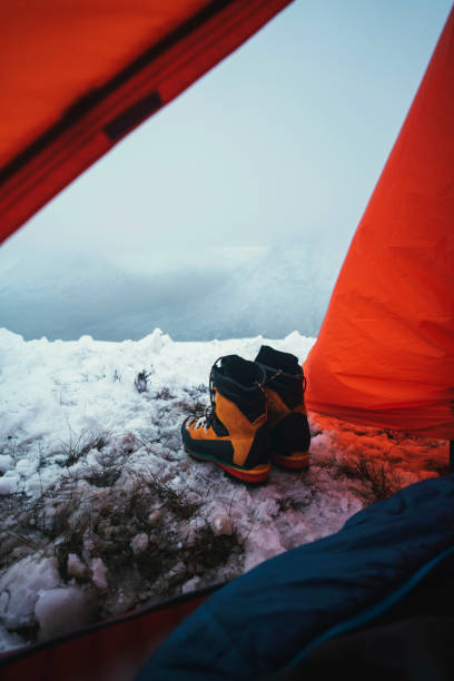 istock Boots at the opening of a tent 2157233385