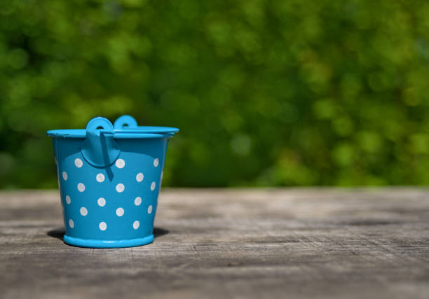 Photo of empty small blue bucket on the table
