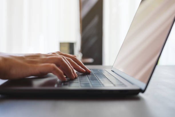 istock Closeup image of a woman hands working and typing on laptop computer keyboard 2157234217