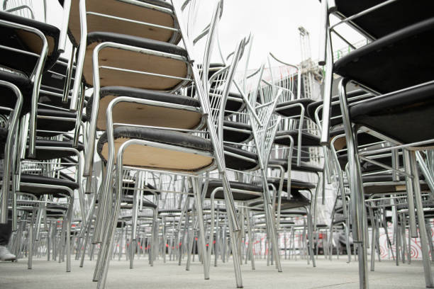 istock Shiny steel chairs stacked outdoor . Low angle view 2157234227