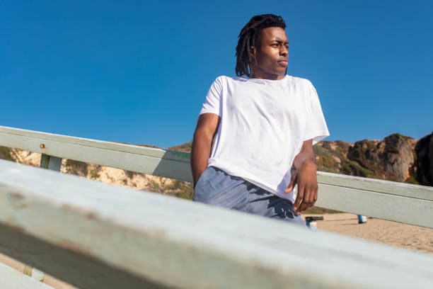 African American man in white tee at the beach