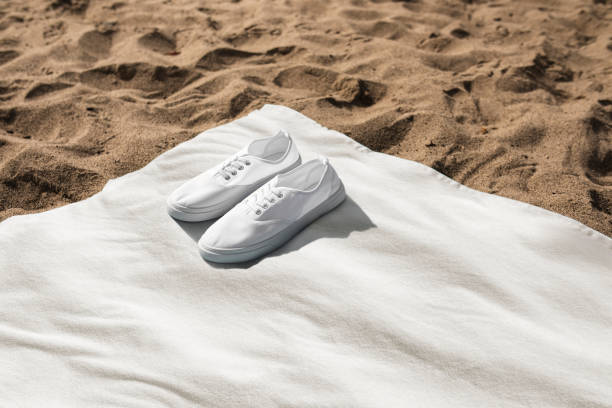 White sneakers on beach towel summer vibes photography