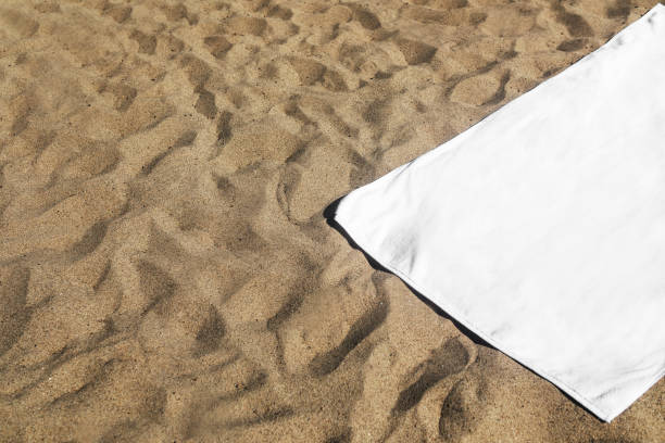 istock White beach towel on the sand 2157235150