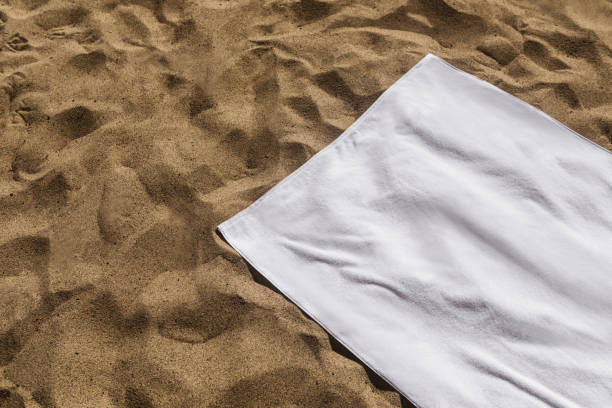istock White beach towel on the sand 2157235174