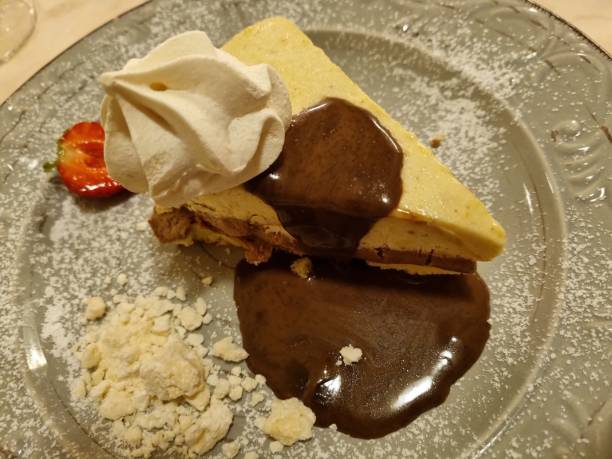 istock Decadent cheesecake with chocolate sauce and strawberry garnish 2157236810
