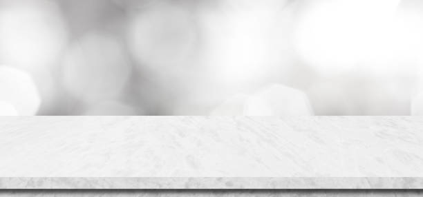 istock Empty white table top, counter, desk background over blur perspective bokeh light background, White marble stone table, shelf and blurred kitchen restaurant for food, product display mockup, template 2157236895