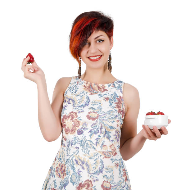 istock Young girl holding a strawberry. Isolated on white 2157238537