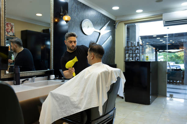 istock A man getting his hair cut at the barber 2157240719