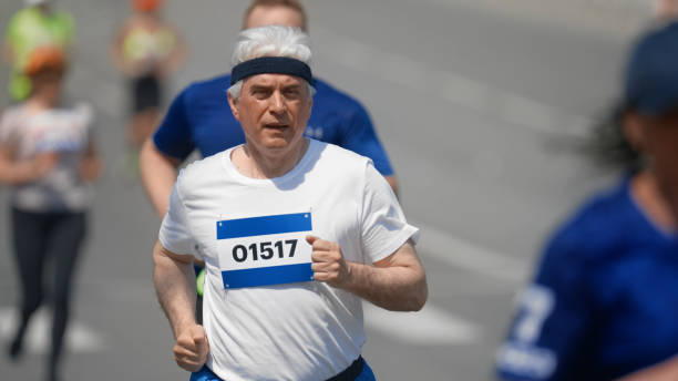 istock Active old man run marathon. Motivation concept. Senior runner. Elder sportsman. 2157243411