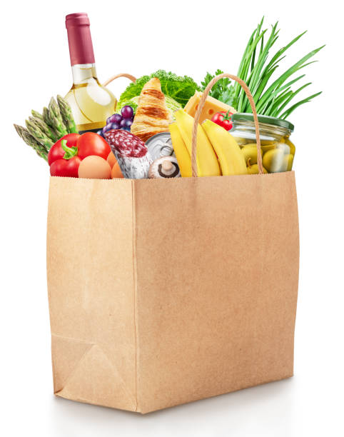 istock Reusable paper shopping bag with fresh organic vegetables, fruits and other grocery products on white background. File contains clipping path. 2157243473