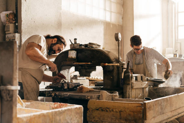 istock Two Men Working on Hydraulic Press Bench Making Cement Tiles in Industrial Workshop 2157243757