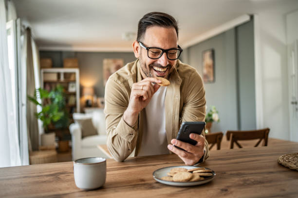 istock Portrait of a middle-aged man using a smartphone at home 2157243956