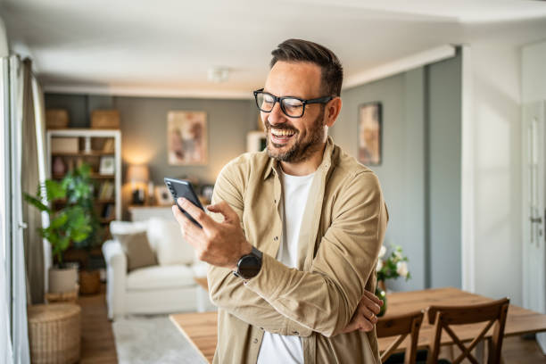 istock Portrait of a middle-aged man using a smartphone at home 2157243985