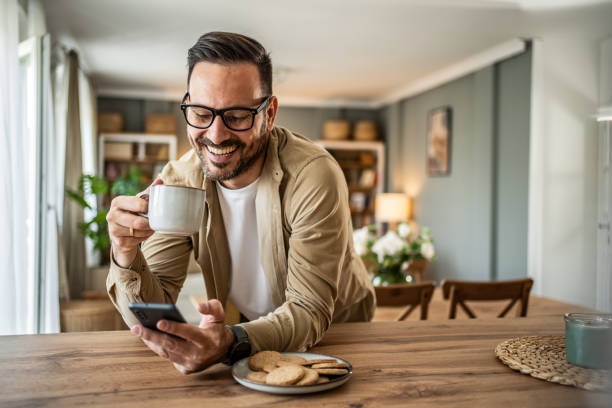 istock Portrait of a middle-aged man using a smartphone at home 2157244038