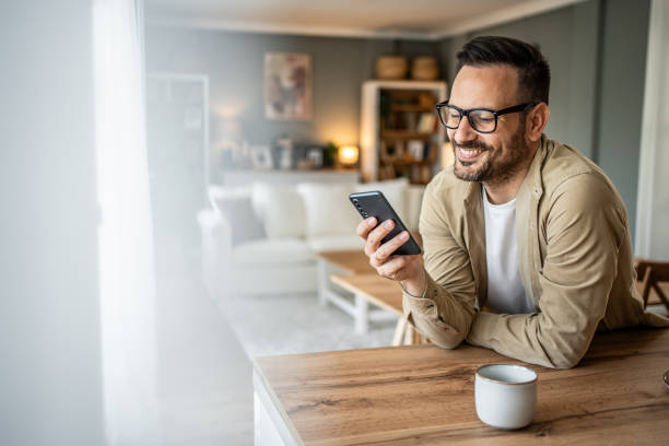 istock Portrait of a middle-aged man using a smartphone at home 2157244108