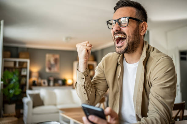 istock Portrait of a middle-aged man using a smartphone at home 2157244125